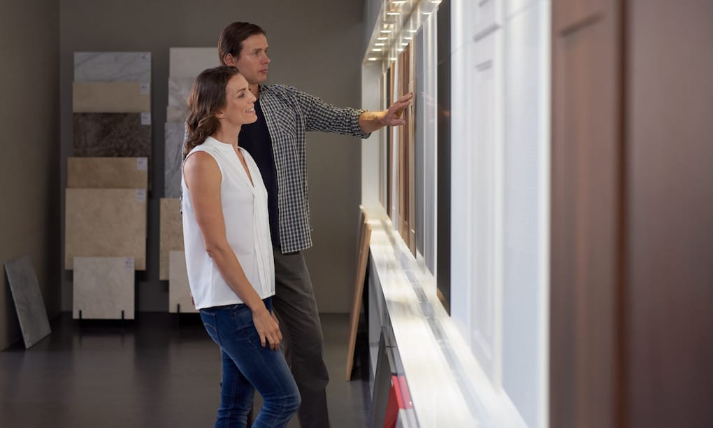 Couple looking at different eco-friendly kitchen cabinets